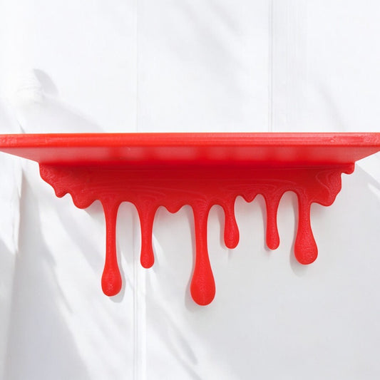 Modern dripping wall shelf with a unique flowing design, mounted on a white wall, showcasing minimalist decor and providing stylish storage for books, plants, or decorative items.