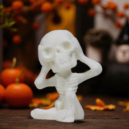 Gothic skeleton statue in beige, small spooky shelf decor.