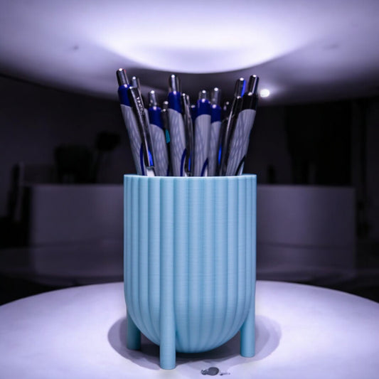 Charming pen holder named Elysian Grace Cup, featuring small feet for a playful touch. Available in various colours, this elegant organizer adds style and functionality to any desk or workspace