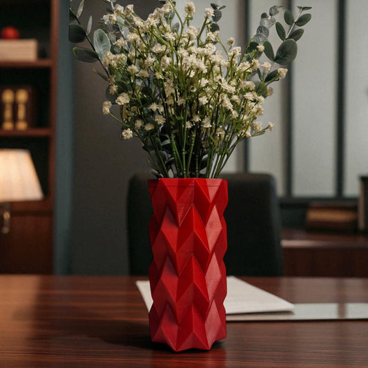 A modern 3D-printed vase with a sleek, sculptural design. Made from durable, waterproof material, this stylish vase is perfect for fresh flowers, dried arrangements, or as a standalone decor piece. Ideal for contemporary and minimalist interiors.