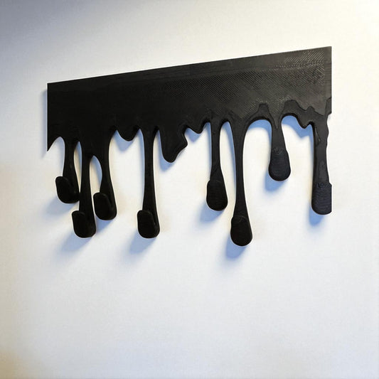 Modern Dripping Key Hanger with a unique dripping paint design, available in small (180mm x 90mm) and large (239mm x 120mm) sizes. Holds up to 9 key sets and can be mounted with adhesive strips for a rent-friendly option or secured with screws for a permanent installation. A stylish and functional wall-mounted key organizer for homes, apartments, and offices.