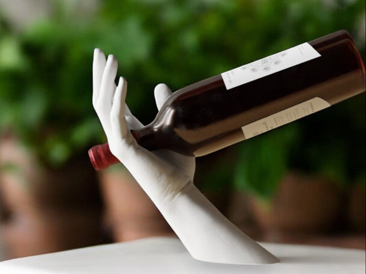 Elegant hand-shaped wine holder with a unique arm design, perfect for stylishly displaying a wine bottle on countertops, dining tables, or home bars.