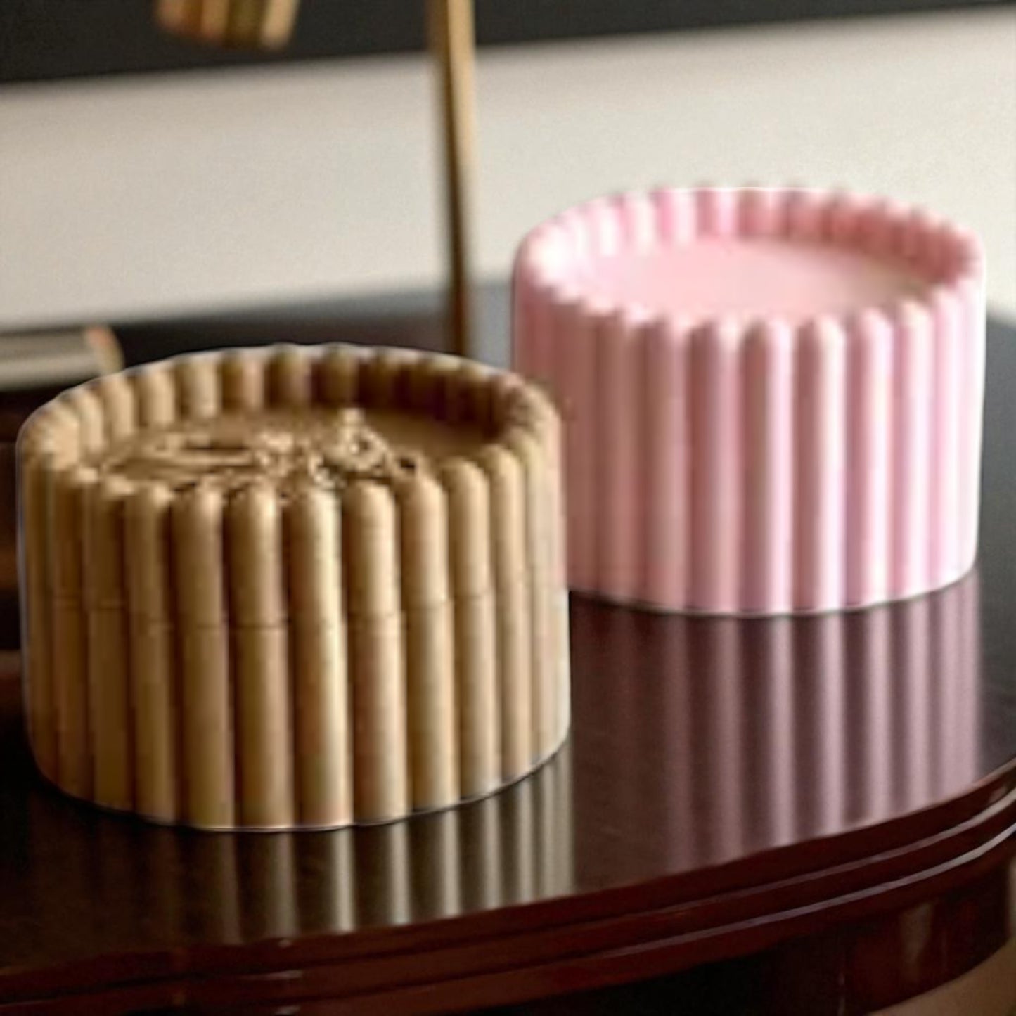 3d printed macaron-style jar with a rounded lid and ribbed cookie-like sides, shown in brown and pink colors, used for vanity or bathroom storage.