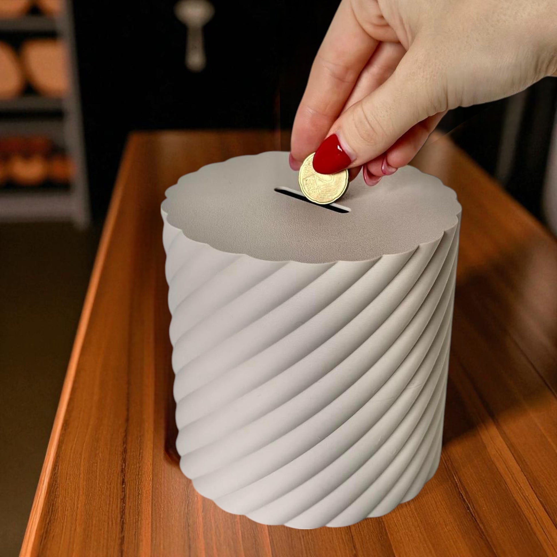 A modern spiral coin bank with a unique closing mechanism. Features a sleek, minimalist design where coins drop smoothly into the bank, and the lid twists shut in a mesmerizing spiral motion. Perfect for stylish and satisfying money-saving!