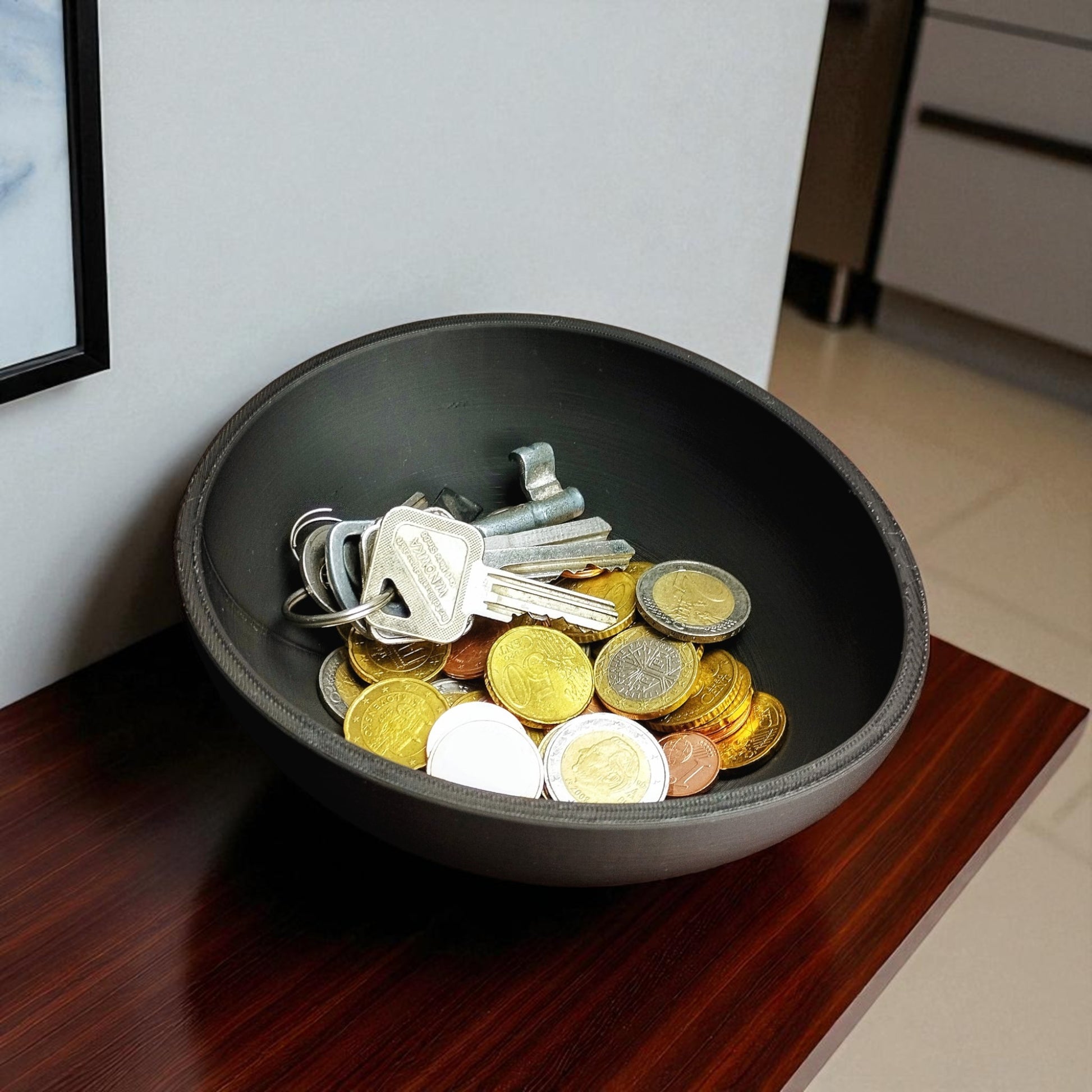 A uniquely designed bowl resembling a slightly crooked egg, perfect for use as a key holder, snack bowl, or fruit bowl, adding a touch of modern charm to any space.