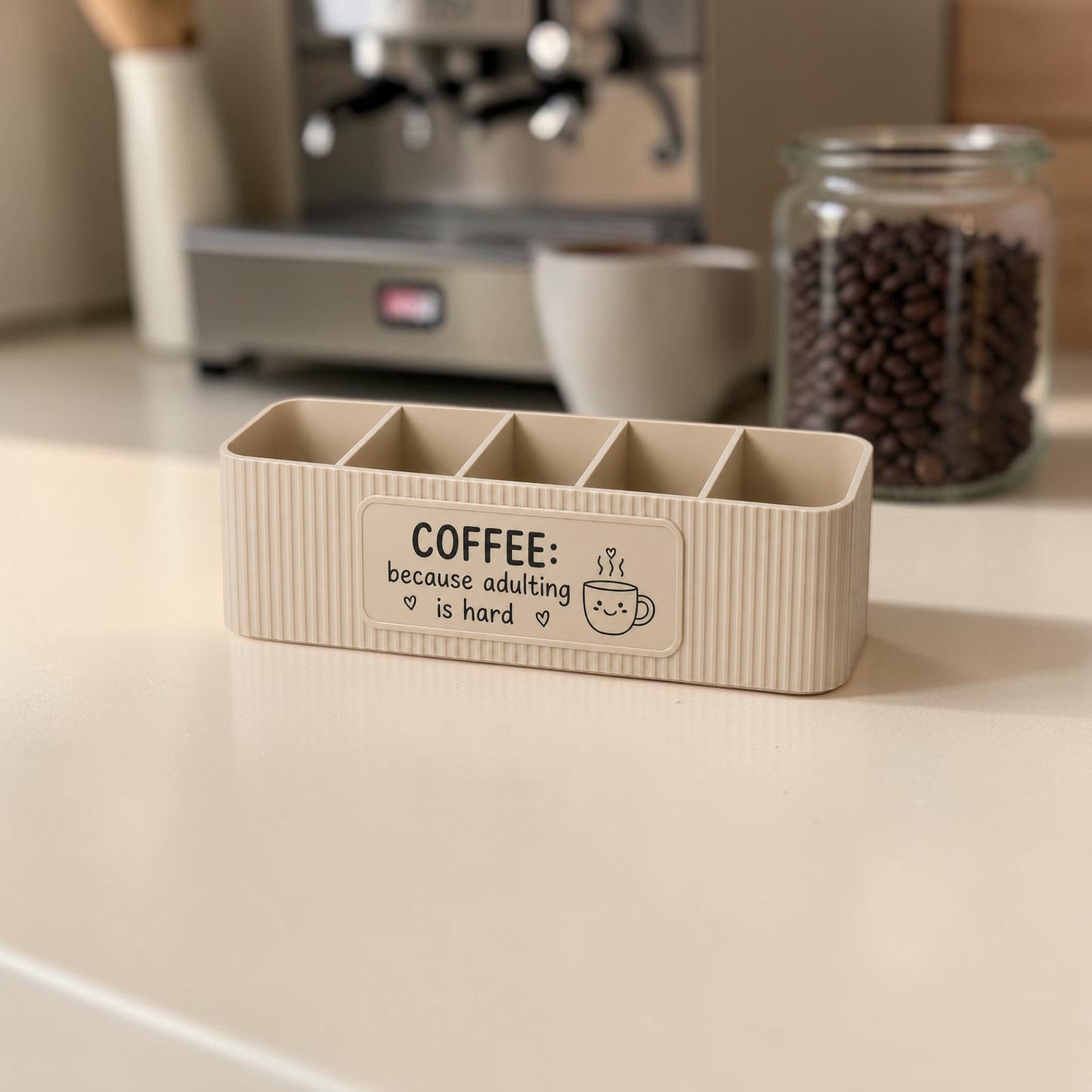 personalised five compartment coffee station organiser with ribbed finish and custom uv printed front message, designed for storing coffee sachets, tea bags, sugar packets, creamer, spoons and stirrers on a kitchen countertop. available in white, caramel, grey, pink, dark blue water and lavender purple.