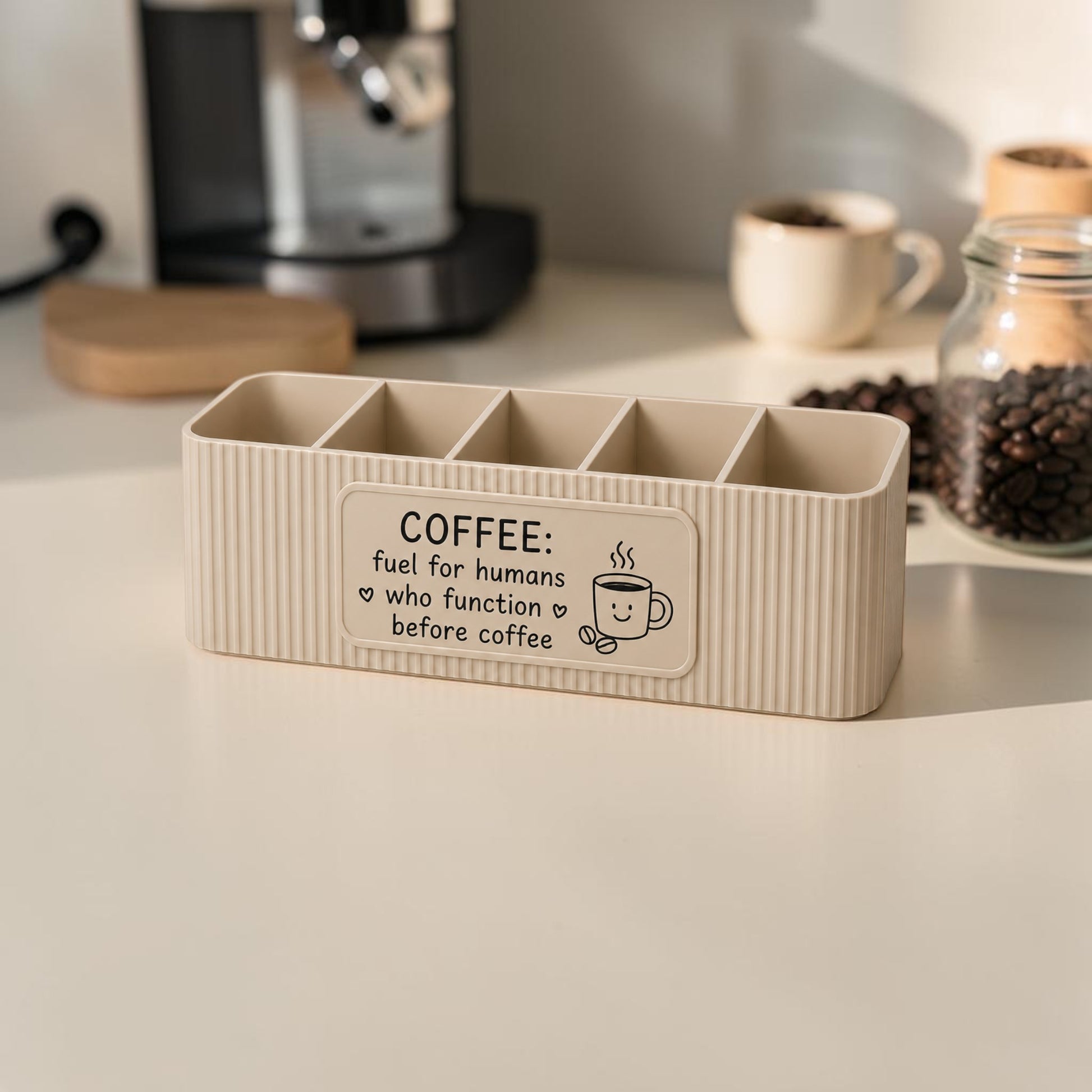 Personalised five compartment coffee station organiser with ribbed finish and custom UV printed front message, designed for storing coffee sachets, tea bags, sugar packets, creamer, spoons and stirrers on a kitchen countertop. Available in white, caramel, grey, pink, dark Blue Water and Lavender Purple.