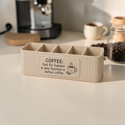 Personalised five compartment coffee station organiser with ribbed finish and custom UV printed front message, designed for storing coffee sachets, tea bags, sugar packets, creamer, spoons and stirrers on a kitchen countertop. Available in white, caramel, grey, pink, dark Blue Water and Lavender Purple.