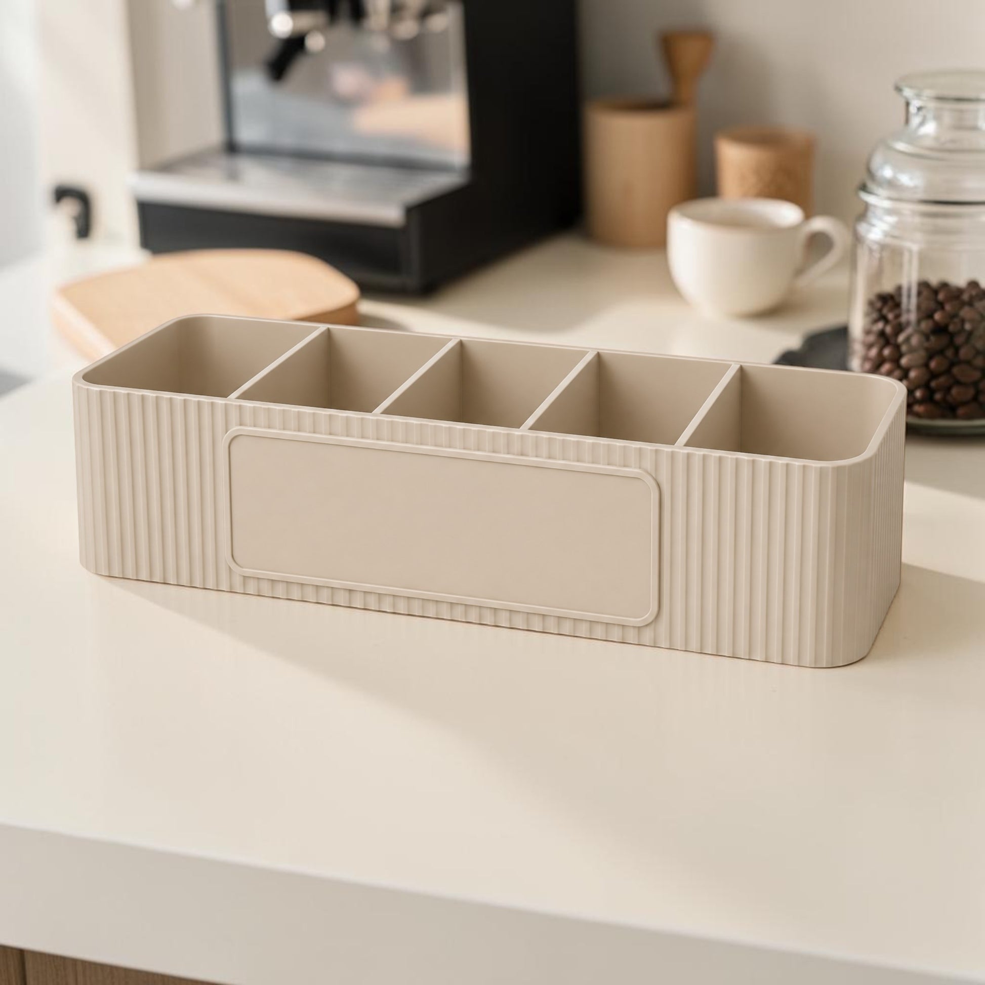 Personalised five compartment coffee station organiser with ribbed finish and custom UV printed front message, designed for storing coffee sachets, tea bags, sugar packets, creamer, spoons and stirrers on a kitchen countertop. Available in white, caramel, grey, pink, dark Blue Water and Lavender Purple.