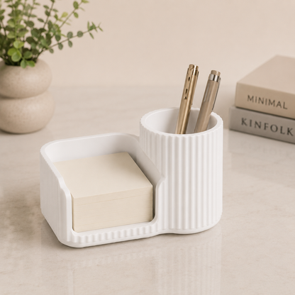 White sticky notes holder and pen organizer on a modern desk.
Black desk organizer with sticky note compartment and pen holder.
Grey desktop organizer holding sticky notes and pens.
Brown stationery organizer for office and study desks.
Caramel coloured desk accessory with pen cup and note holder.
Sakura pink sticky notes holder for cute desk decor.