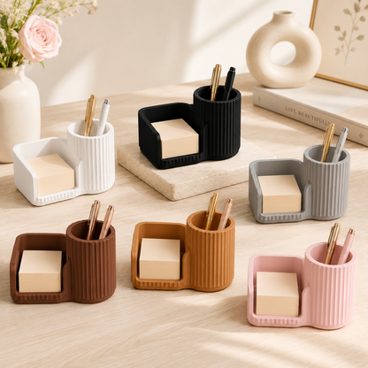 White sticky notes holder and pen organizer on a modern desk.
Black desk organizer with sticky note compartment and pen holder.
Grey desktop organizer holding sticky notes and pens.
Brown stationery organizer for office and study desks.
Caramel coloured desk accessory with pen cup and note holder.
Sakura pink sticky notes holder for cute desk decor.