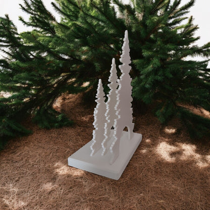 White Christmas reindeer and pine tree LED tealight decoration glowing on table, festive holiday décor for mantel or centerpiece.