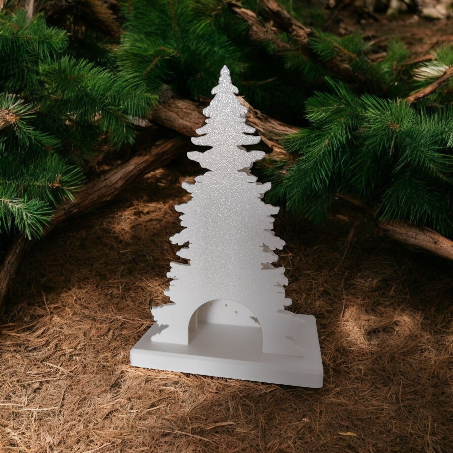 white christmas reindeer and pine tree led tealight decoration glowing on table, festive holiday décor for mantel or centerpiece.