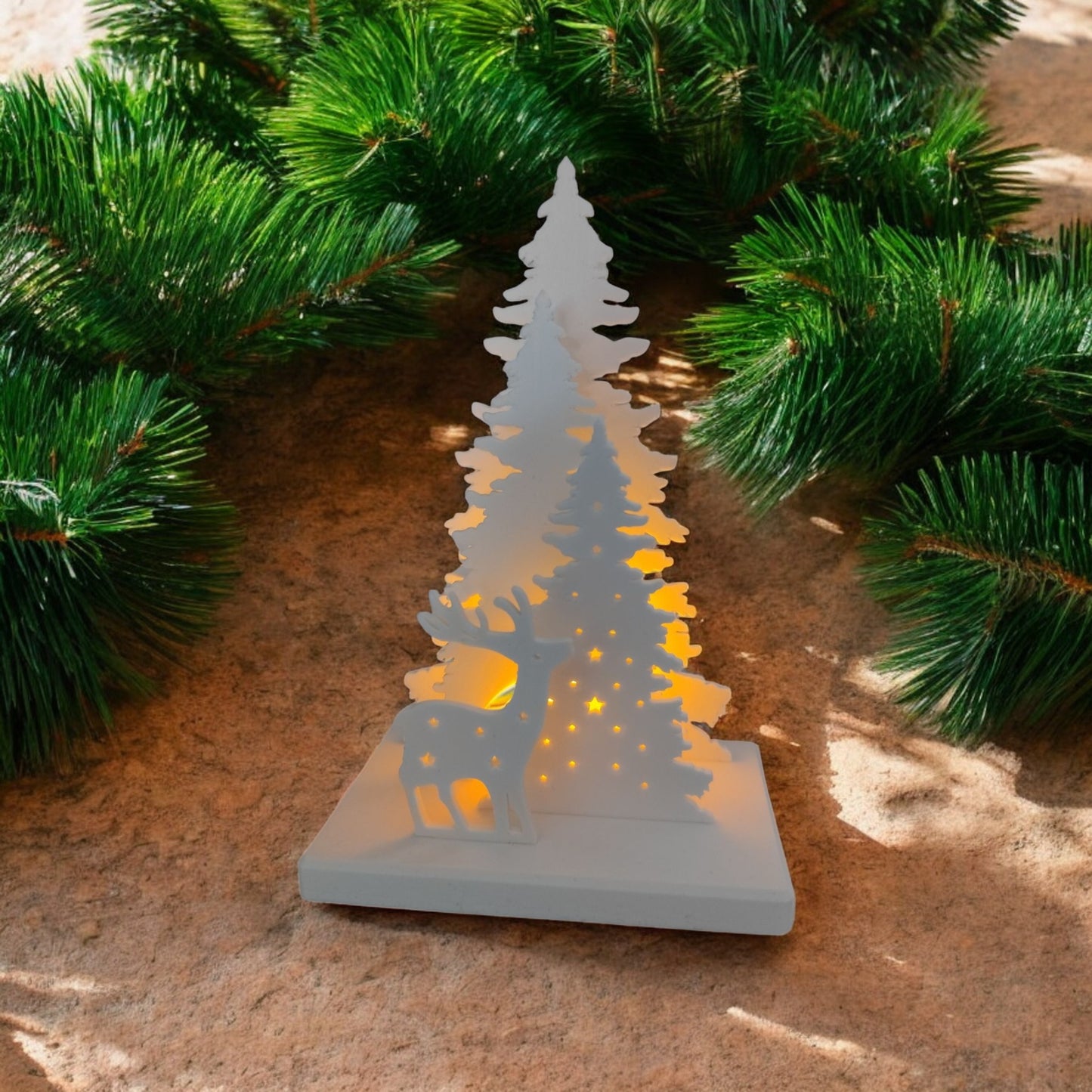 white christmas reindeer and pine tree led tealight decoration glowing on table, festive holiday décor for mantel or centerpiece.