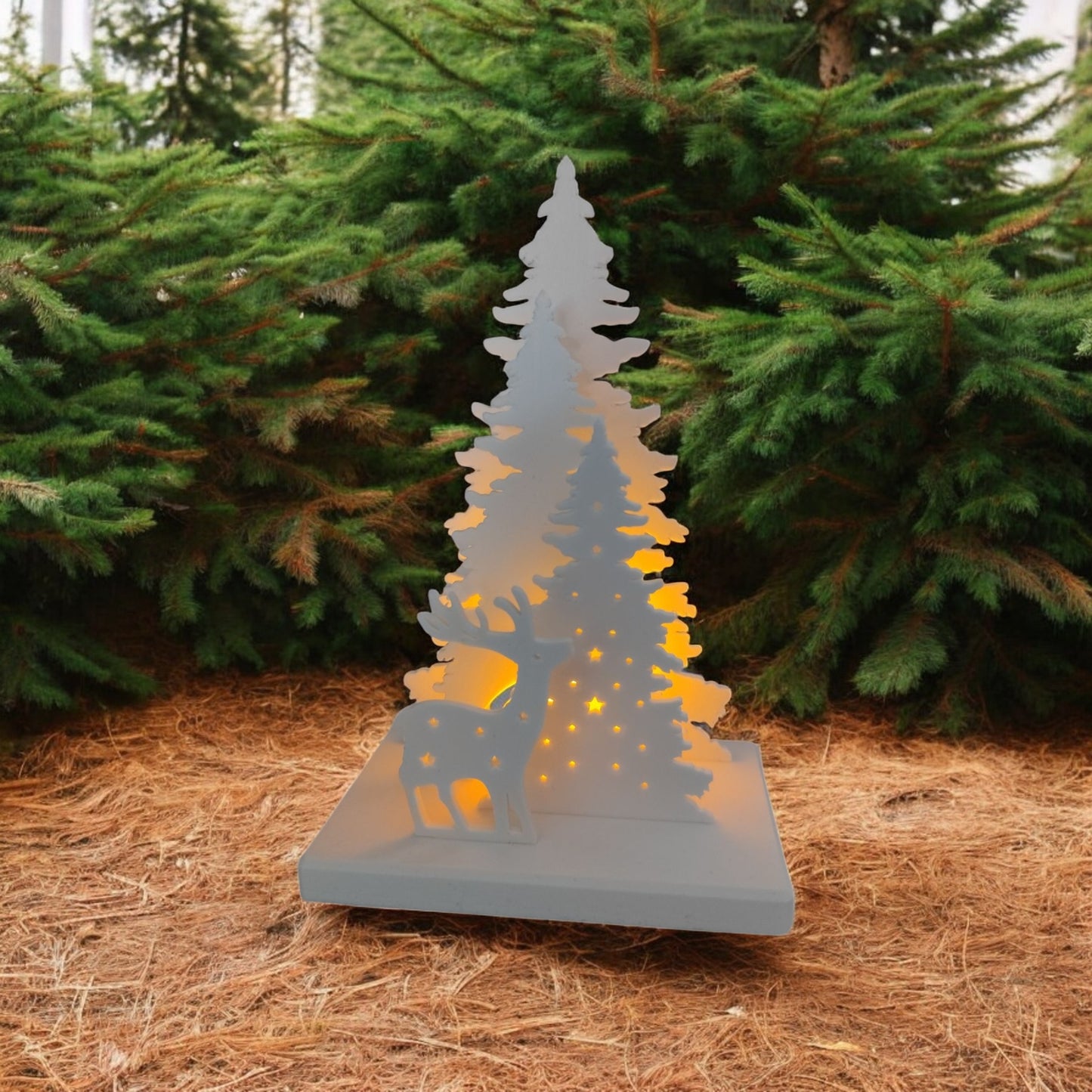 white christmas reindeer and pine tree led tealight decoration glowing on table, festive holiday décor for mantel or centerpiece.