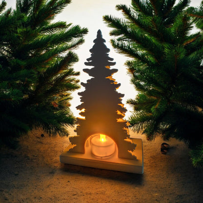 White Christmas reindeer and pine tree LED tealight decoration glowing on table, festive holiday décor for mantel or centerpiece.