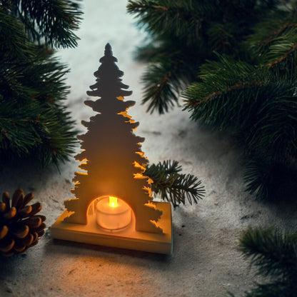 White Christmas reindeer and pine tree LED tealight decoration glowing on table, festive holiday décor for mantel or centerpiece.