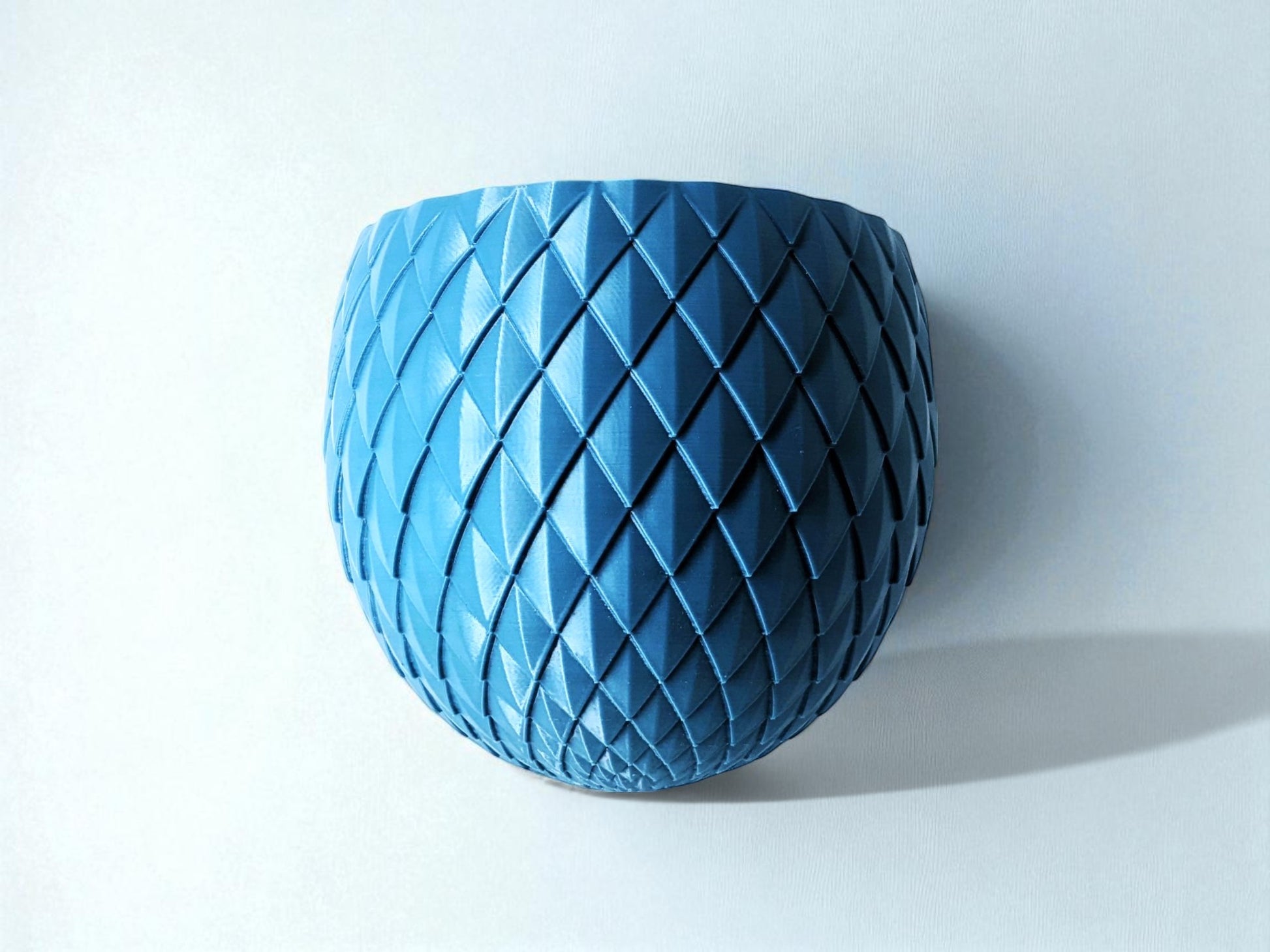 Blue textured vase on a light gray background