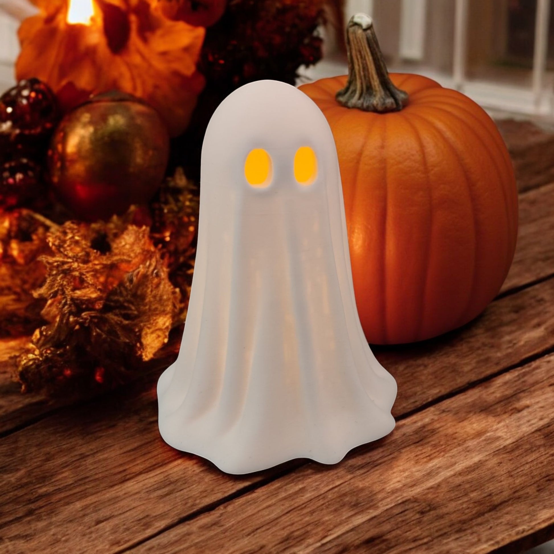 Set of 3 glowing ghost LED tealight holders in small, medium, and large sizes, for indoor or outdoor Halloween decor.