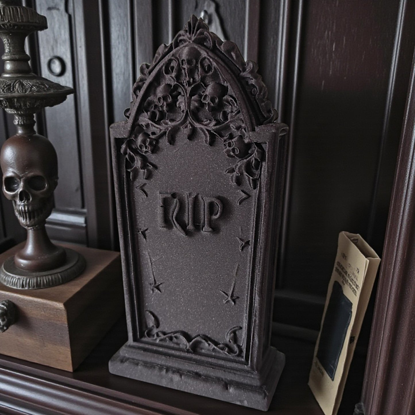 3d printed gothic gravestone with skull details and “rip” engraving, available in black, grey, and white, shown as halloween or gothic table decor.