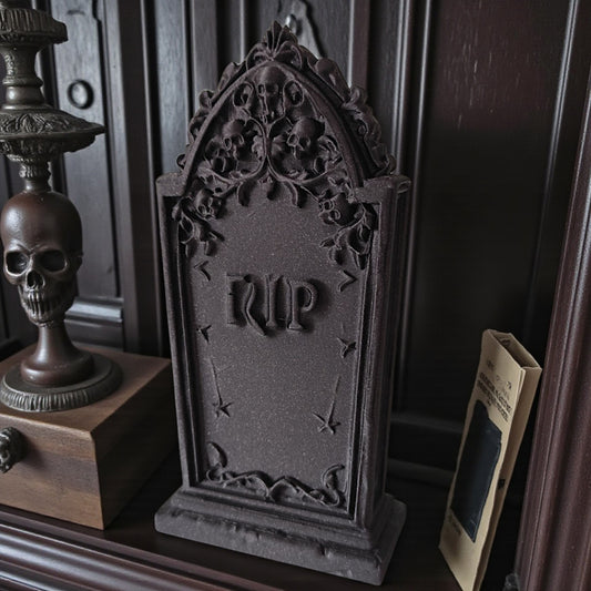 3D printed gothic gravestone with skull details and “RIP” engraving, available in black, grey, and white, shown as Halloween or gothic table decor.