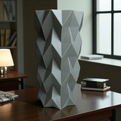 A modern 3D-printed vase with a sleek, sculptural design. Made from durable, waterproof material, this stylish vase is perfect for fresh flowers, dried arrangements, or as a standalone decor piece. Ideal for contemporary and minimalist interiors.