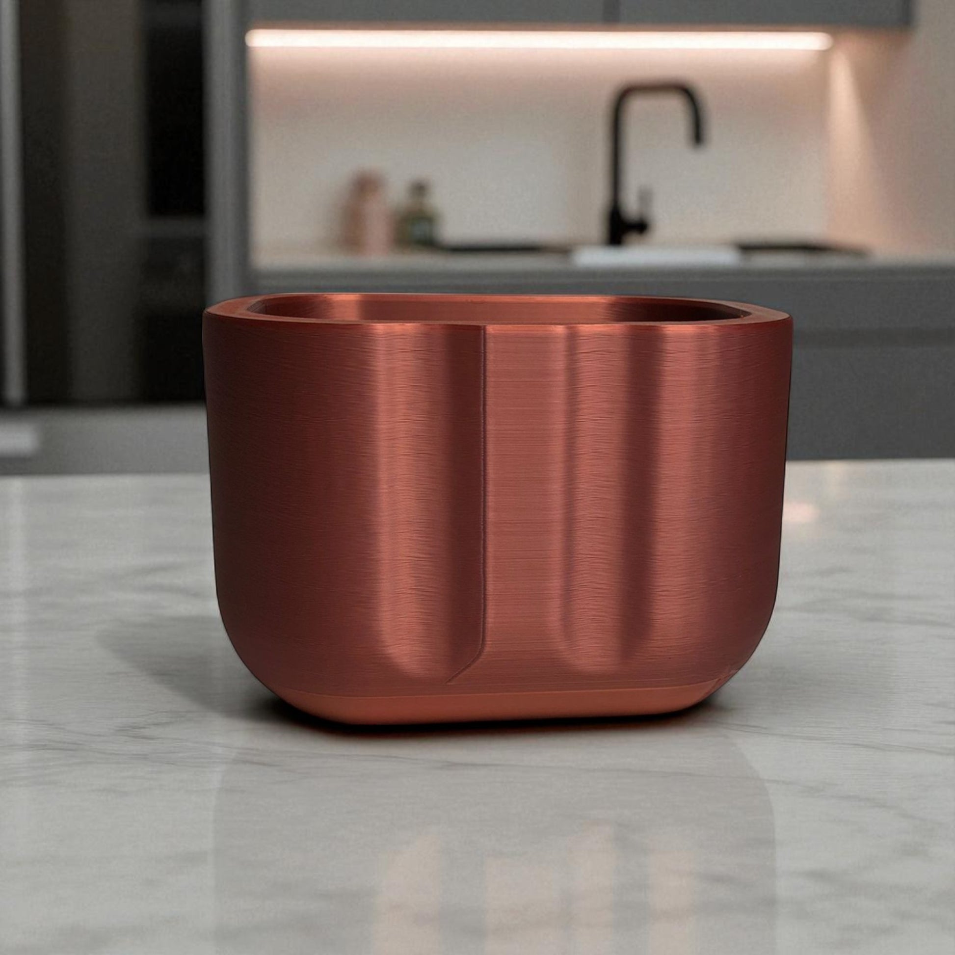 Black sponge holder with a yellow sponge on a kitchen counter
