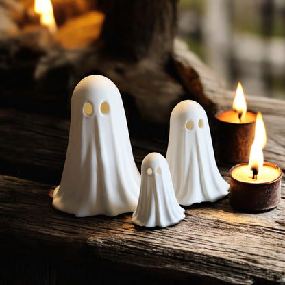 Set of 3 glowing ghost LED tealight holders in small, medium, and large sizes, for indoor or outdoor Halloween decor.