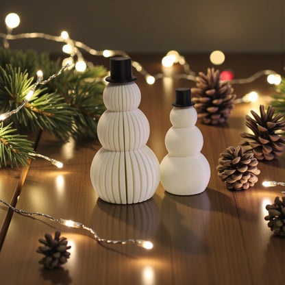 Two white snowman figurines, one ribbed and one smooth, each with a small black top hat. Minimalist Christmas decor displayed on a countertop in small and large sizes.