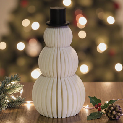 Two white snowman figurines, one ribbed and one smooth, each with a small black top hat. Minimalist Christmas decor displayed on a countertop in small and large sizes.
