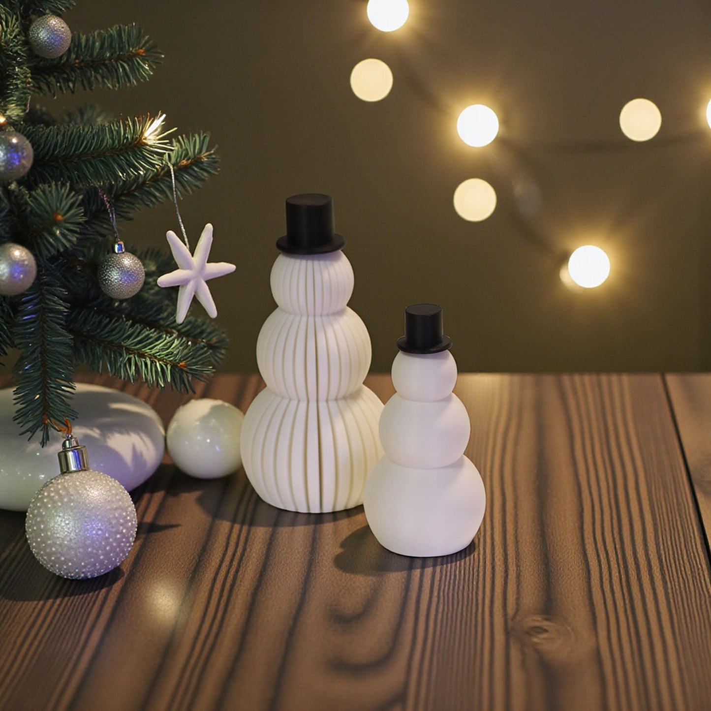 two white snowman figurines, one ribbed and one smooth, each with a small black top hat. minimalist christmas decor displayed on a countertop in small and large sizes.