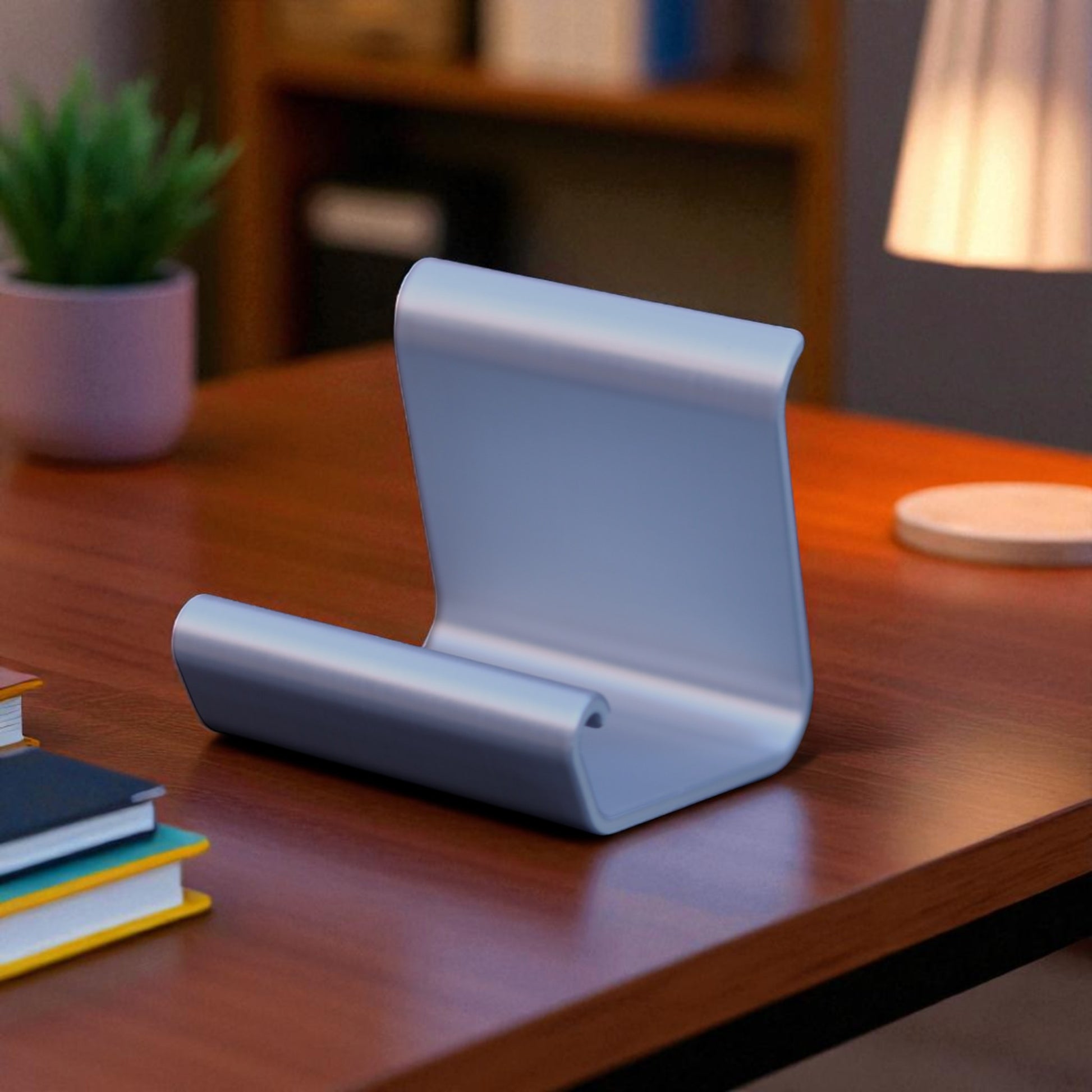 Ergonomic phone holder made of durable 3D-printed material, designed with a sleek and modern look. It securely holds your phone at an optimal angle for comfortable viewing, making it perfect for desks, nightstands, or kitchen counters. Compact, stylish, and practical for everyday use