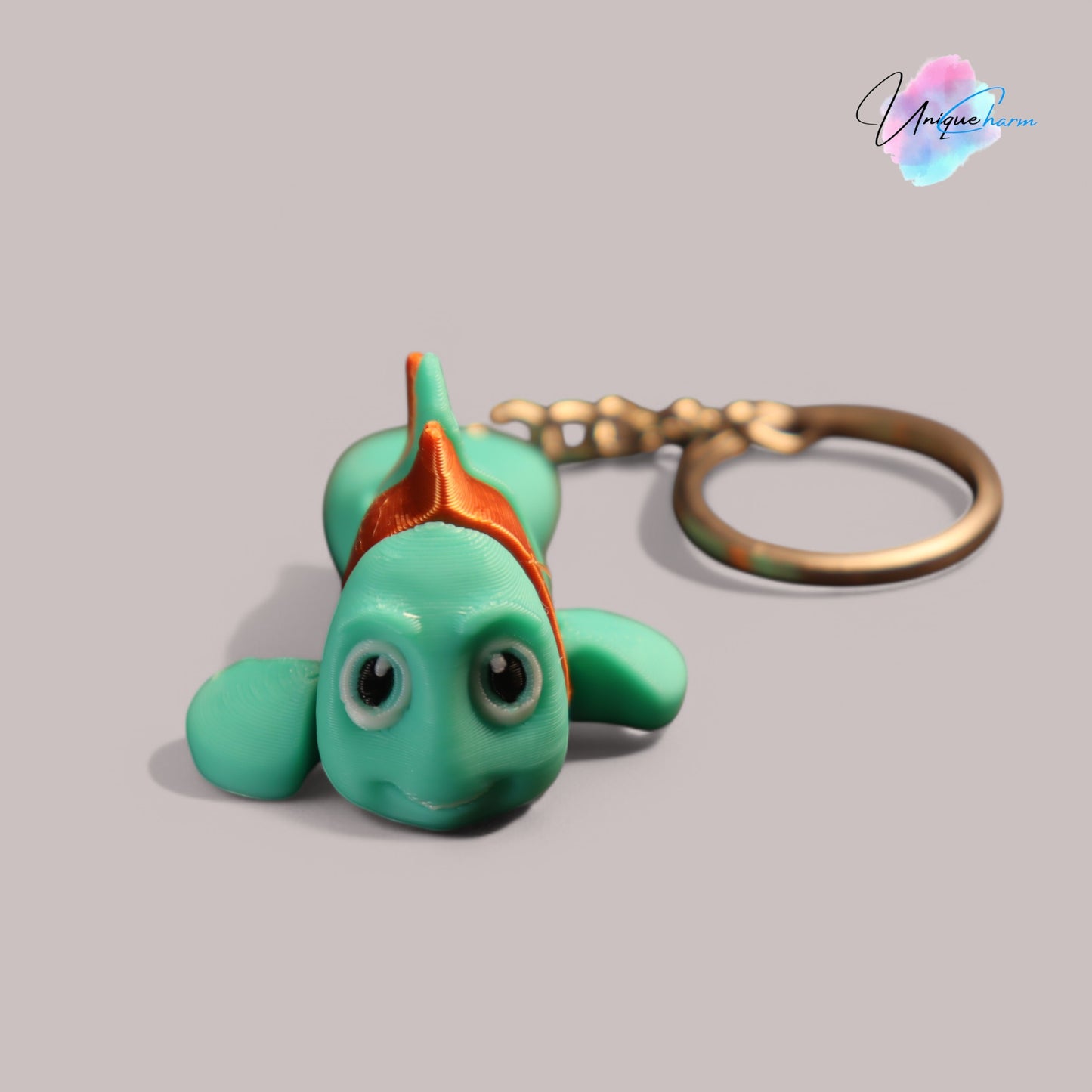 3d printed articulated clown fish toy in vibrant two-tone colors, featuring a cute face and flexible, lifelike movement, perfect as a keychain or playful ocean-themed gift.