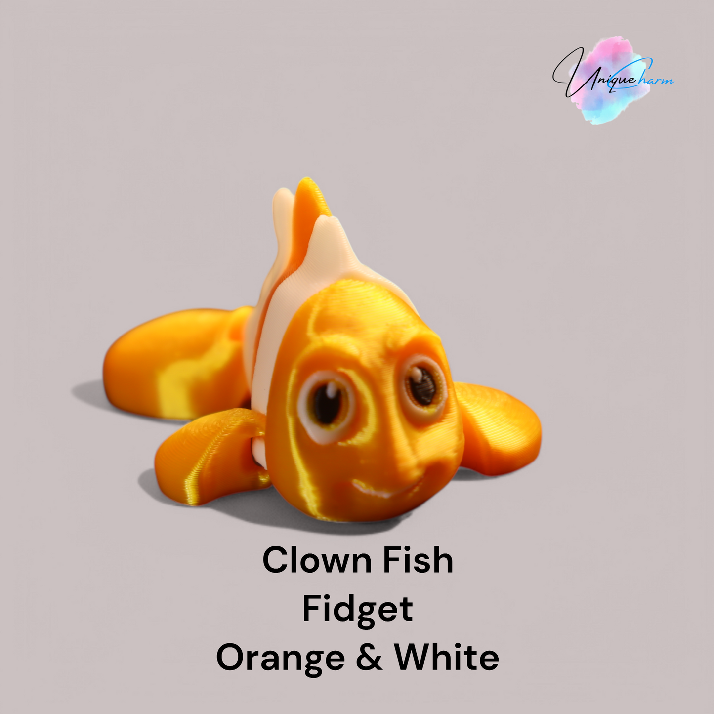 3d printed articulated clown fish toy in vibrant two-tone colors, featuring a cute face and flexible, lifelike movement, perfect as a keychain or playful ocean-themed gift.