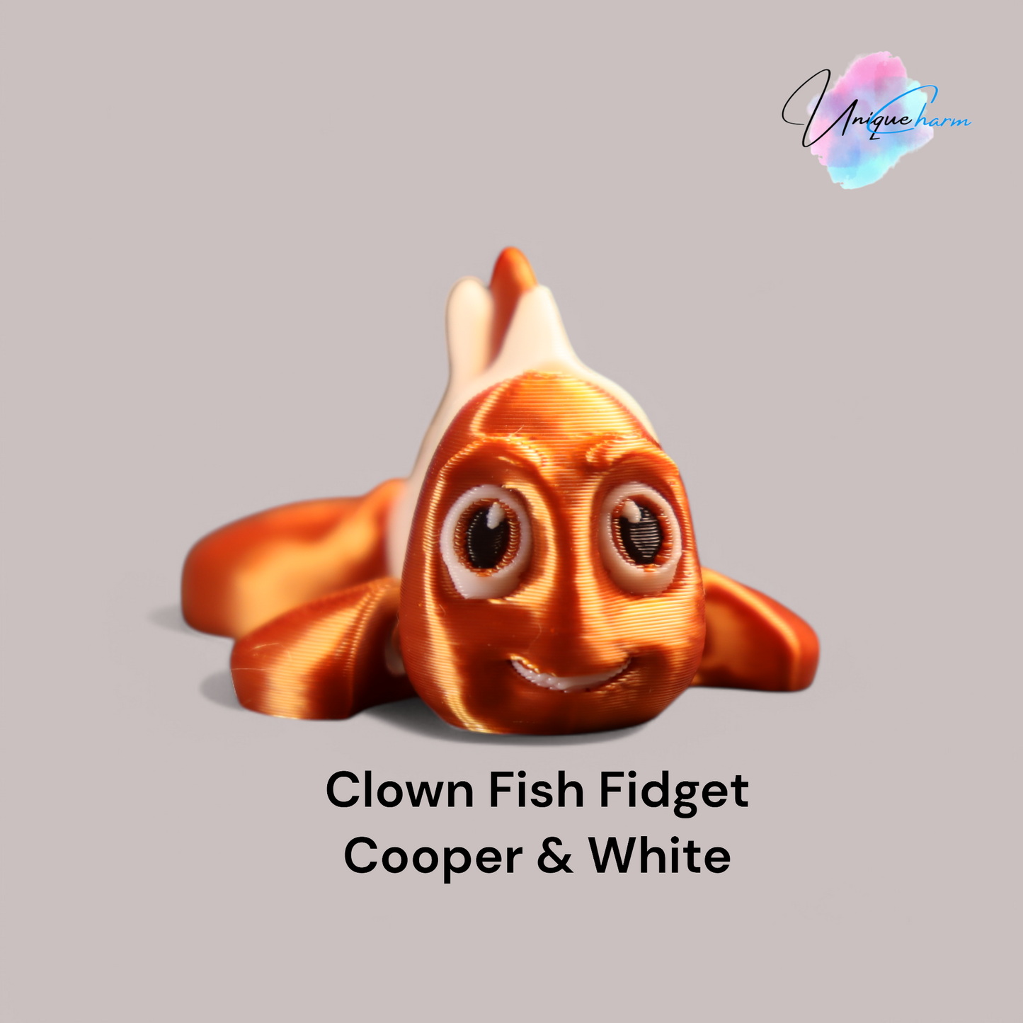 3d printed articulated clown fish toy in vibrant two-tone colors, featuring a cute face and flexible, lifelike movement, perfect as a keychain or playful ocean-themed gift.