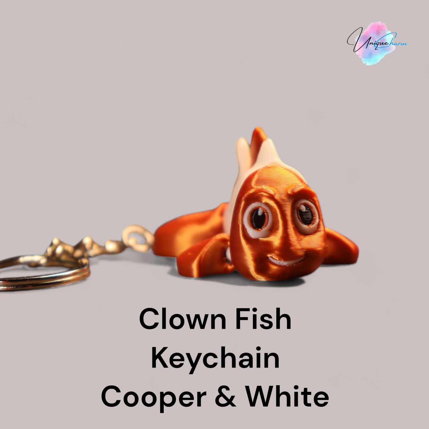 3d printed articulated clown fish toy in vibrant two-tone colors, featuring a cute face and flexible, lifelike movement, perfect as a keychain or playful ocean-themed gift.