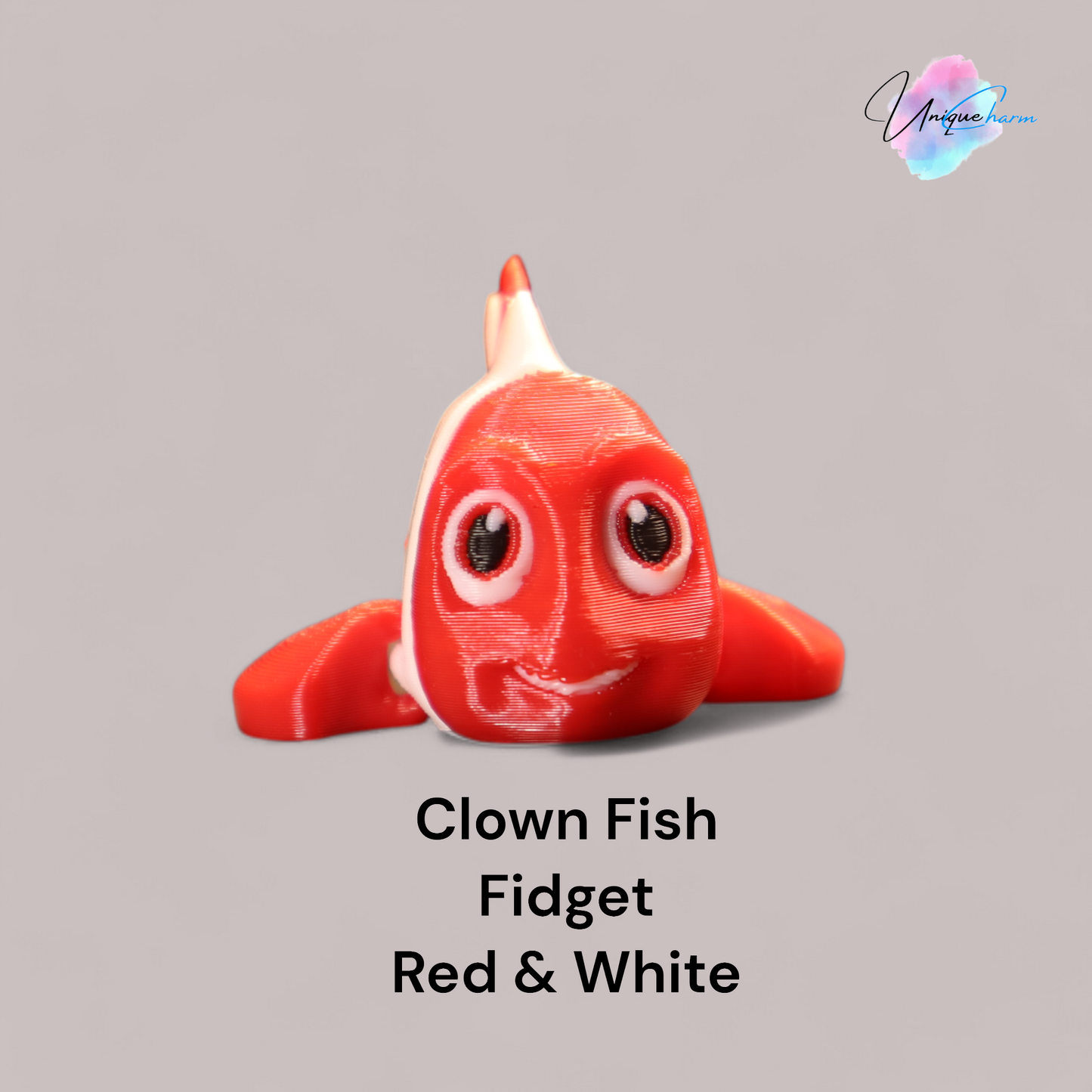 3d printed articulated clown fish toy in vibrant two-tone colors, featuring a cute face and flexible, lifelike movement, perfect as a keychain or playful ocean-themed gift.