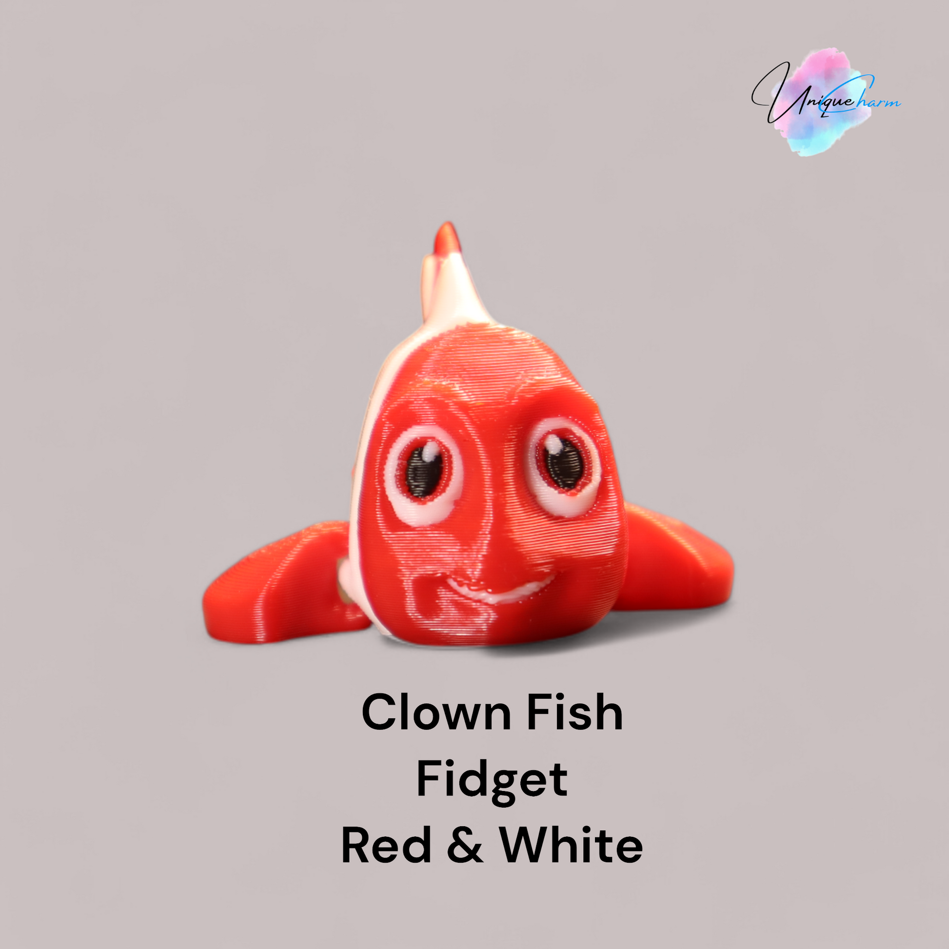 3D printed articulated clown fish toy in vibrant two-tone colors, featuring a cute face and flexible, lifelike movement, perfect as a keychain or playful ocean-themed gift.