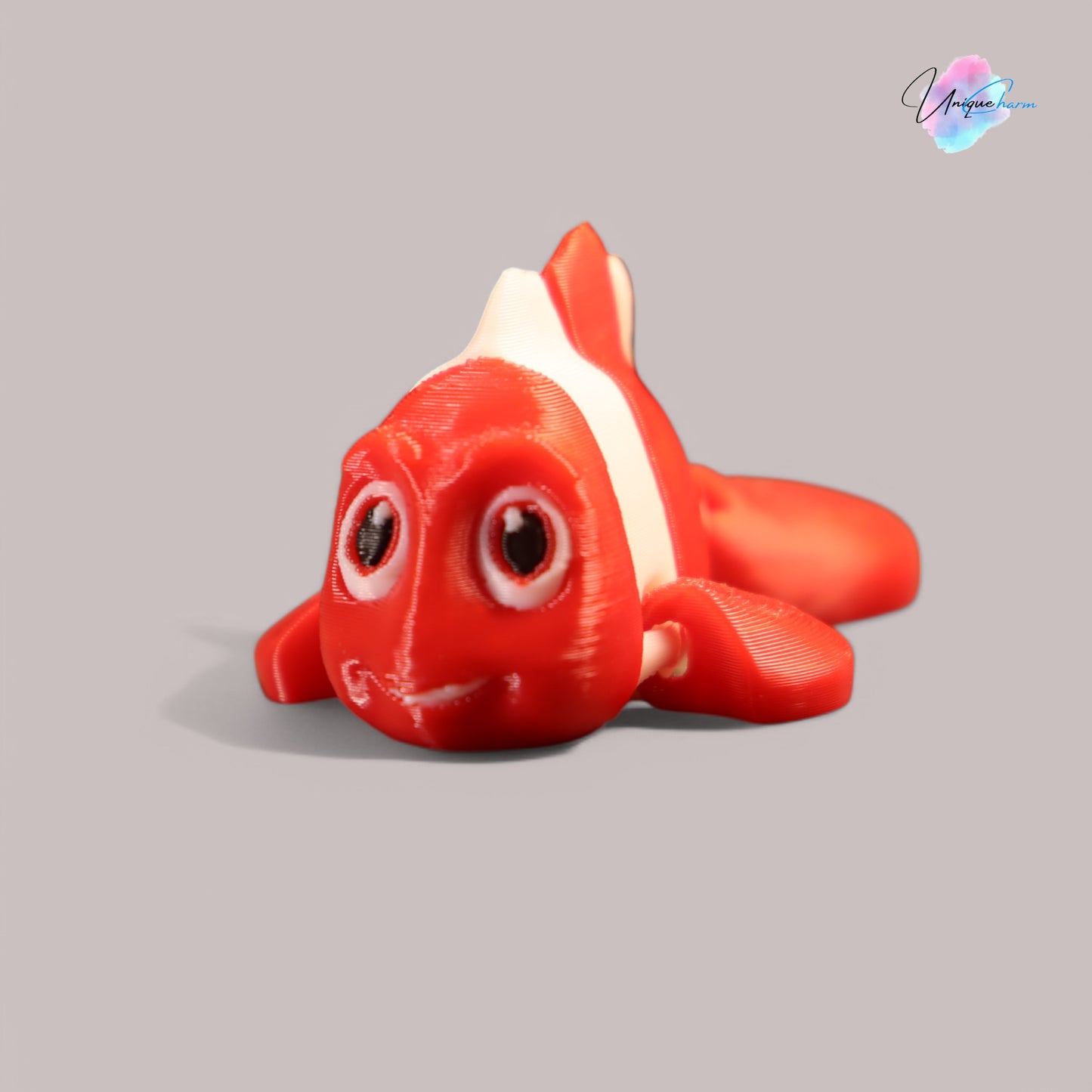 3d printed articulated clown fish toy in vibrant two-tone colors, featuring a cute face and flexible, lifelike movement, perfect as a keychain or playful ocean-themed gift.