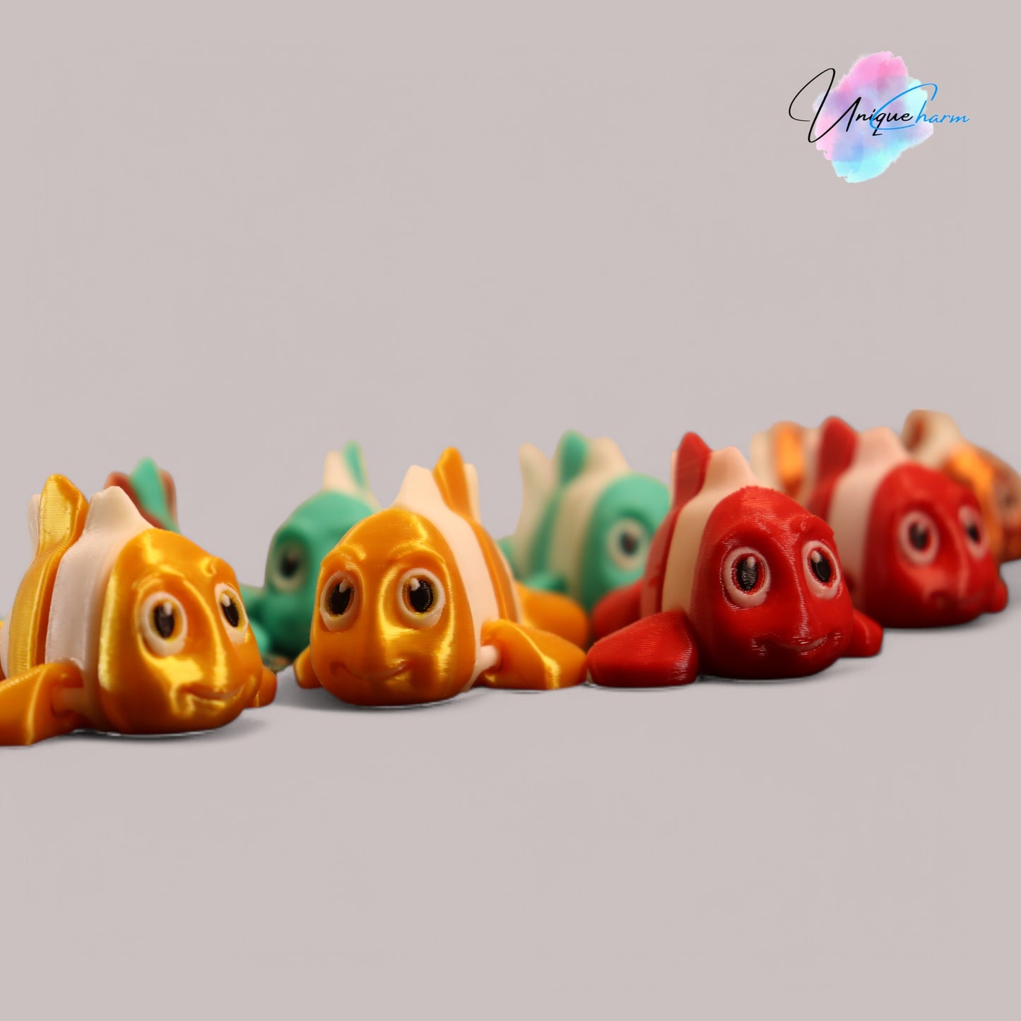 3d printed articulated clown fish toy in vibrant two-tone colors, featuring a cute face and flexible, lifelike movement, perfect as a keychain or playful ocean-themed gift.