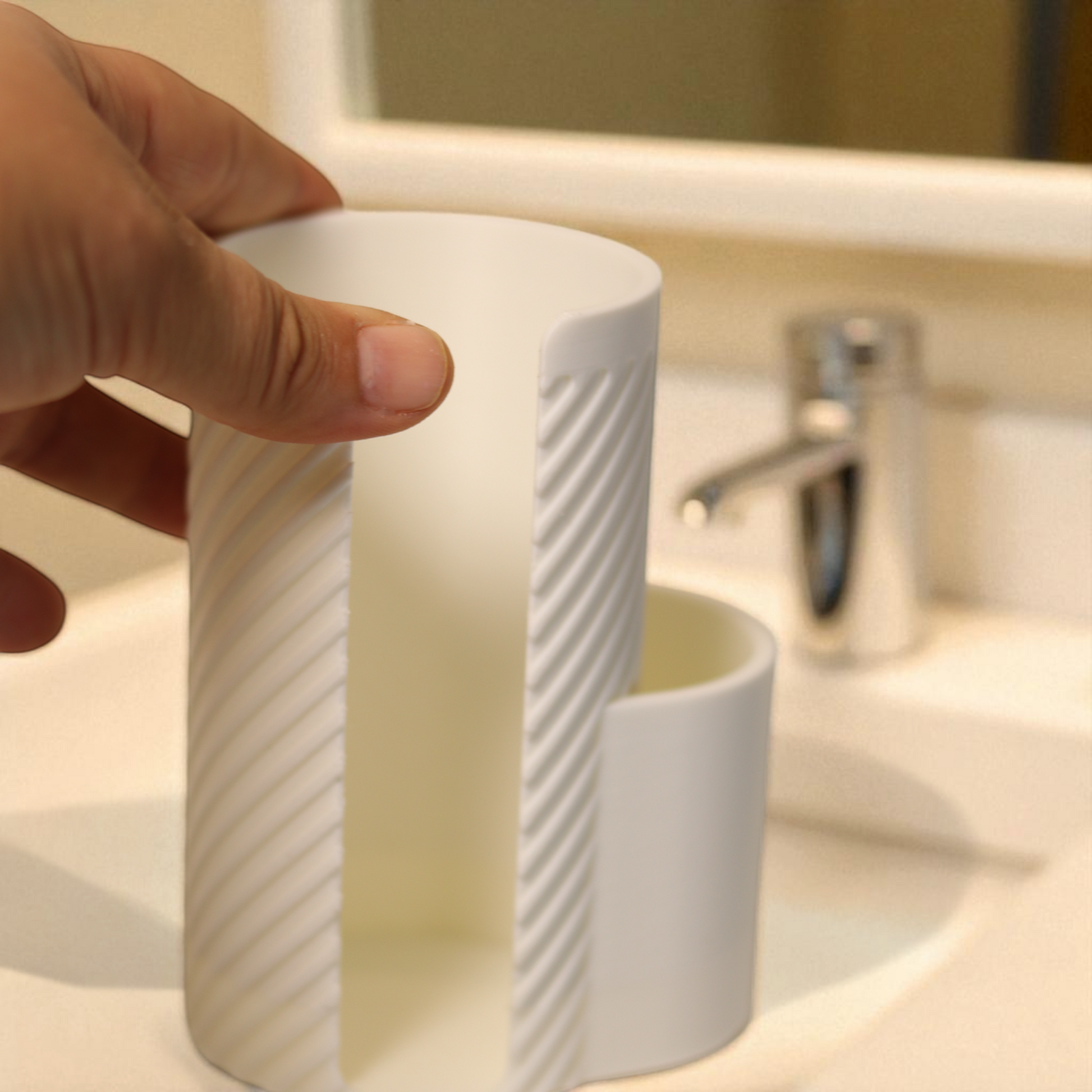 White makeup cotton pad holder with side cup for cotton buds on a vanity; minimal bathroom organizer for cotton rounds and Q-tips.