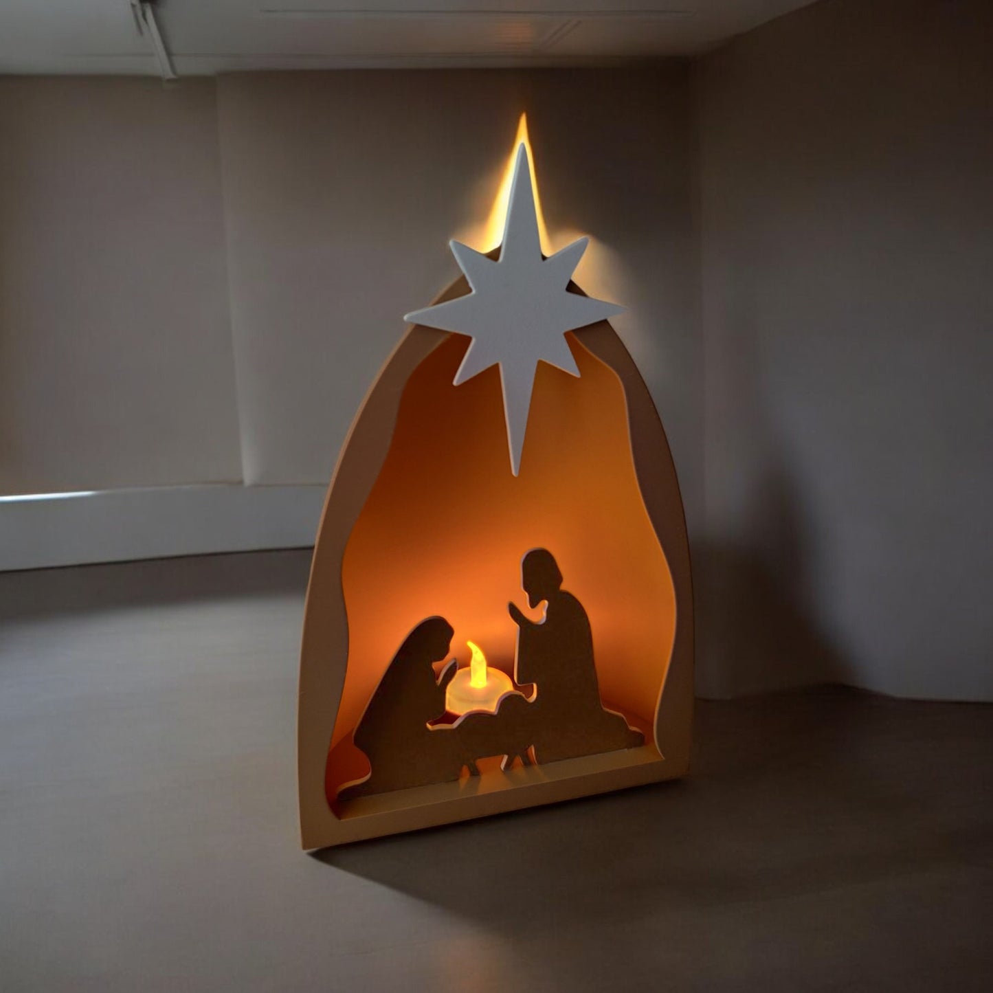 handmade nativity scene decoration displayed with a stable silhouette, holy family figures, star on top and optional led tealight, shown in a soft neutral colour. modern christmas home décor piece measuring 28.5 cm tall, 19 cm wide and 10 cm deep