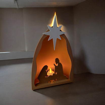 Handmade nativity scene decoration displayed with a stable silhouette, Holy Family figures, star on top and optional LED tealight, shown in a soft neutral colour. Modern Christmas home décor piece measuring 28.5 cm tall, 19 cm wide and 10 cm deep