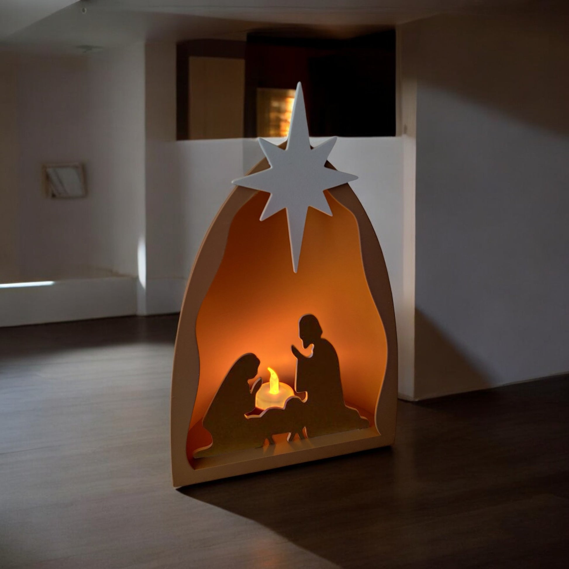 Handmade nativity scene decoration displayed with a stable silhouette, Holy Family figures, star on top and optional LED tealight, shown in a soft neutral colour. Modern Christmas home décor piece measuring 28.5 cm tall, 19 cm wide and 10 cm deep