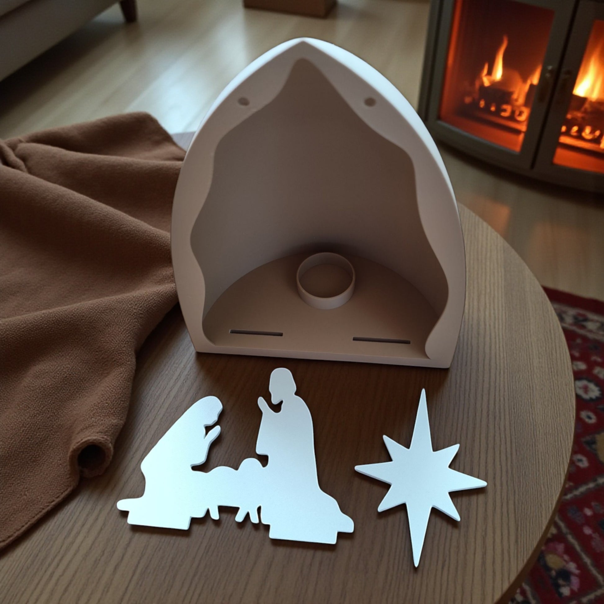 Handmade nativity scene decoration displayed with a stable silhouette, Holy Family figures, star on top and optional LED tealight, shown in a soft neutral colour. Modern Christmas home décor piece measuring 28.5 cm tall, 19 cm wide and 10 cm deep