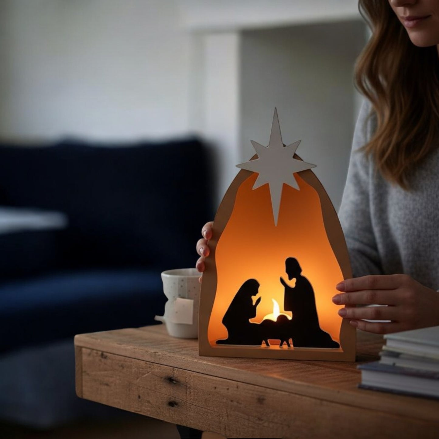 handmade nativity scene decoration displayed with a stable silhouette, holy family figures, star on top and optional led tealight, shown in a soft neutral colour. modern christmas home décor piece measuring 28.5 cm tall, 19 cm wide and 10 cm deep