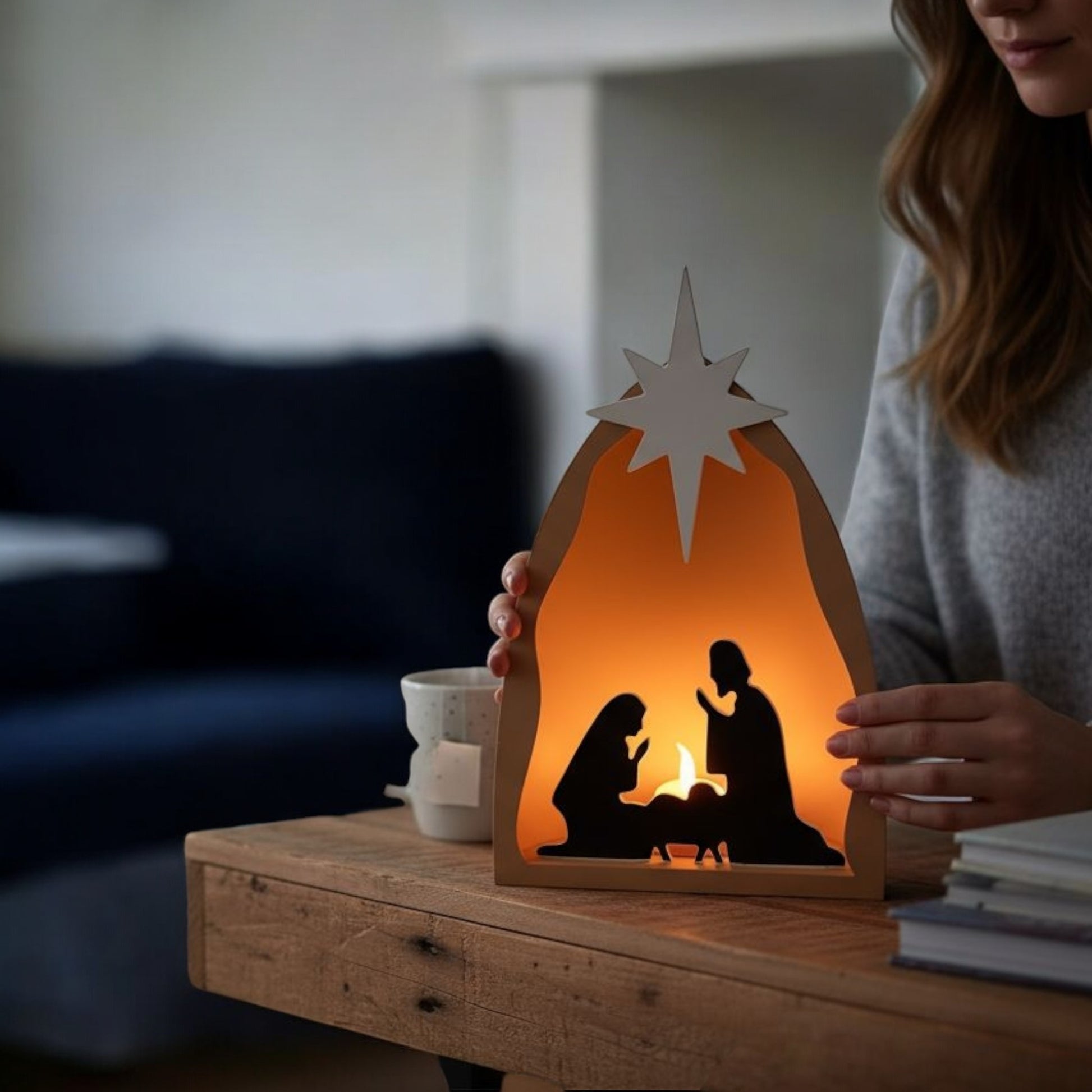Handmade nativity scene decoration displayed with a stable silhouette, Holy Family figures, star on top and optional LED tealight, shown in a soft neutral colour. Modern Christmas home décor piece measuring 28.5 cm tall, 19 cm wide and 10 cm deep