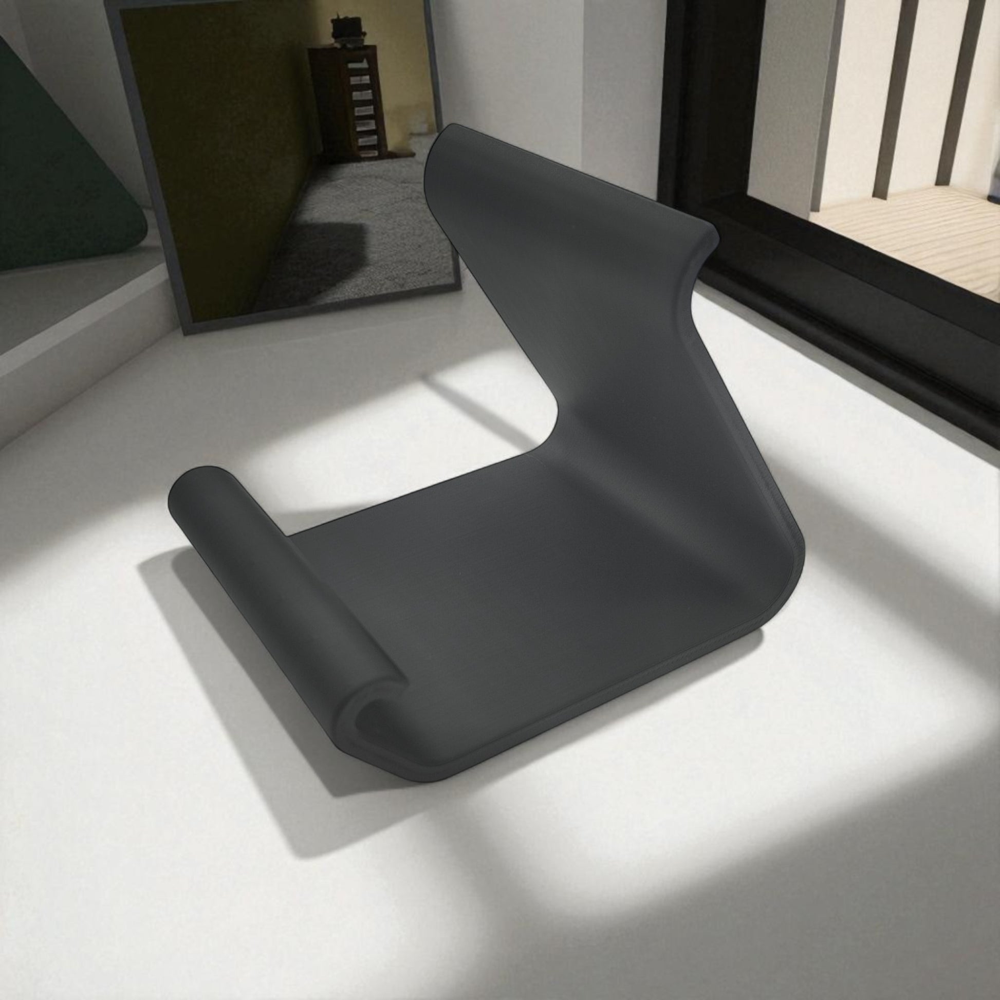 Ergonomic phone holder made of durable 3D-printed material, designed with a sleek and modern look. It securely holds your phone at an optimal angle for comfortable viewing, making it perfect for desks, nightstands, or kitchen counters. Compact, stylish, and practical for everyday use