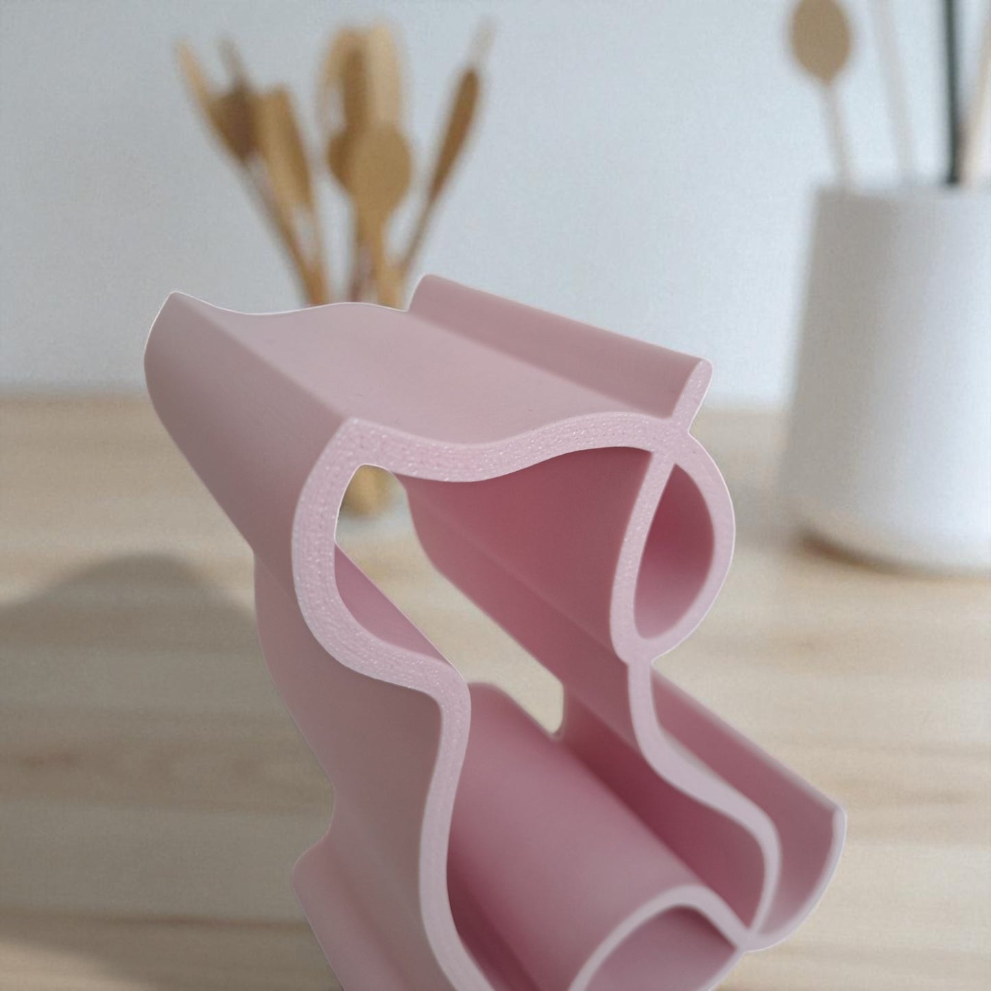 3d printed pink dog-shaped phone holder for desk, used to support a smartphone, tablet, or kindle, ideal for pet lovers and home office decor