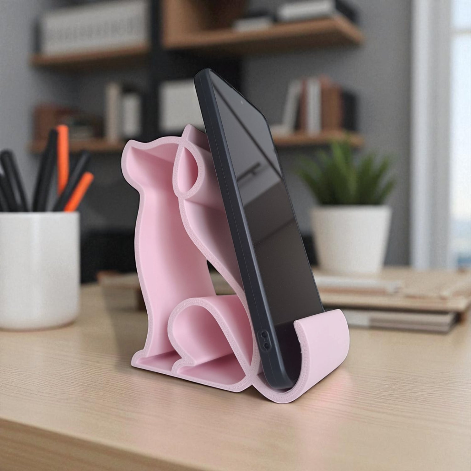 3D printed pink dog-shaped phone holder for desk, used to support a smartphone, tablet, or Kindle, ideal for pet lovers and home office decor